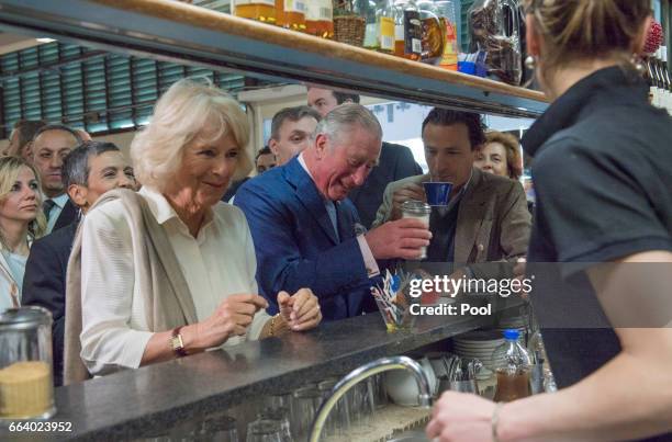 Prince Charles, Prince of Wales pours sugar into his coffee as Camilla, Duchess of Cornwall waits for her drink at the start their day with a coffee...