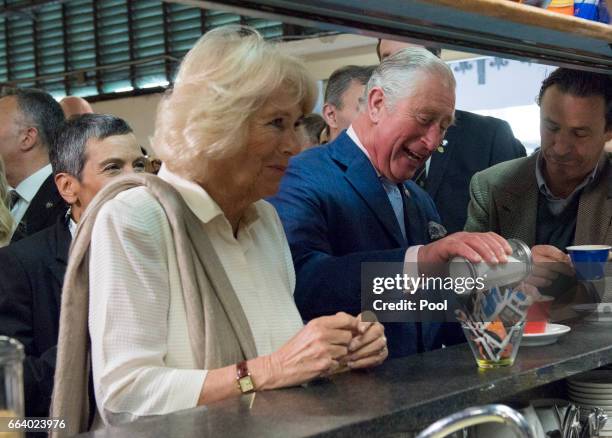 Prince Charles, Prince of Wales pours sugar into his coffee as Camilla, Duchess of Cornwall waits for her drink at the start their day with a coffee...