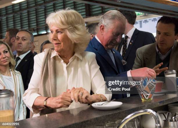 Prince Charles, Prince of Wales pours sugar into his coffee as Camilla, Duchess of Cornwall waits for her drink at the start their day with a coffee...