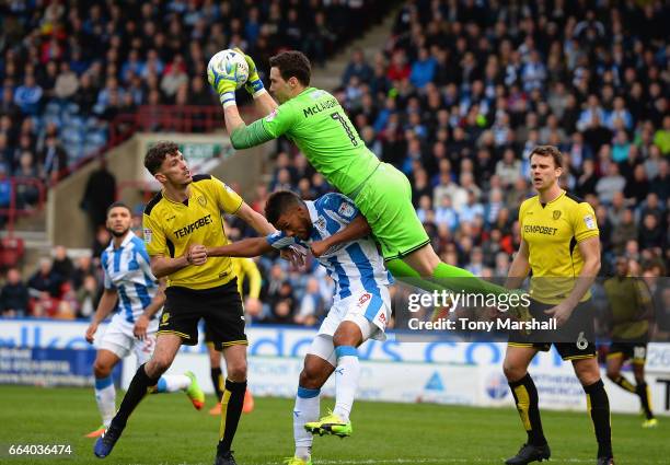 Jon McLaughlin of Burton Albion catches the ball over Elias Kachunga of Huddersfield Town during the Sky Bet Championship match between Huddersfield...