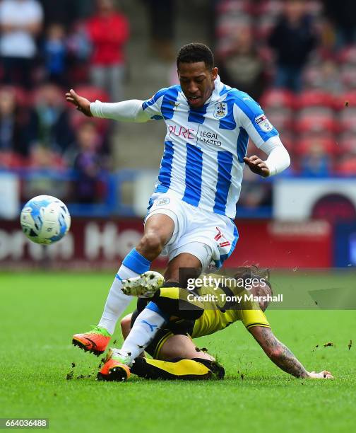 Rajiv Van La Parra of Huddersfield Town is tackled by John Brayford of Burton Albion during the Sky Bet Championship match between Huddersfield Town...