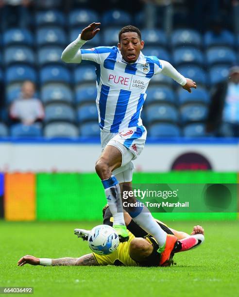 Rajiv Van La Parra of Huddersfield Town is tackled by Michael Kightly of Burton Albion during the Sky Bet Championship match between Huddersfield...