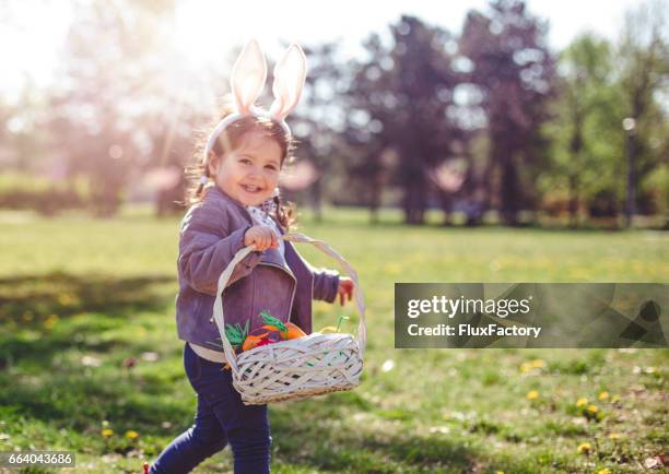 proudly carrying easter eggs - easter stock pictures, royalty-free photos & images