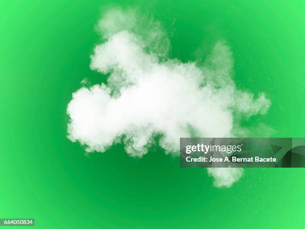 explosion of a cloud of powder of particles of  colors white on a  green background - partícula stock pictures, royalty-free photos & images