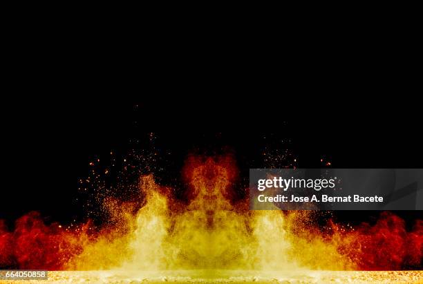 blackground of particles of yellow powder in ascending movement floating in the air produced by an impact - partícula stock pictures, royalty-free photos & images