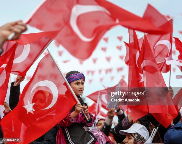 Girl sits on her mother's shoulders as people gather to listen Turkish President Recep Tayyip Erdogan's speech during a mass opening ceremony in...