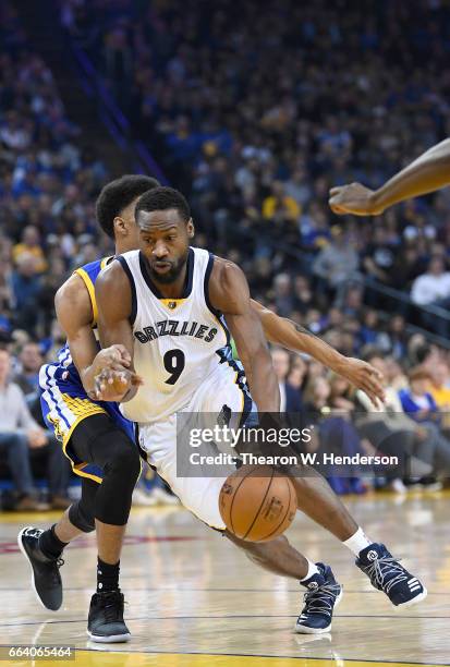 Tony Allen of the Memphis Grizzlies drives on Patrick McCaw of the Golden State Warriors during an NBA basketball game at ORACLE Arena on March 26,...