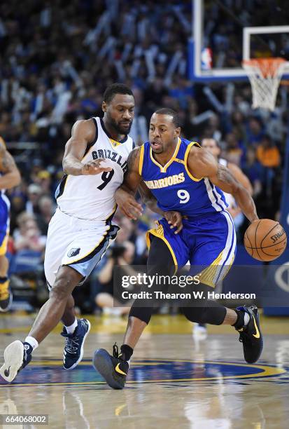 Andre Iguodala of the Golden State Warriors dribbles the ball up the court on offense while guarded by Tony Allen of the Memphis Grizzlies during an...