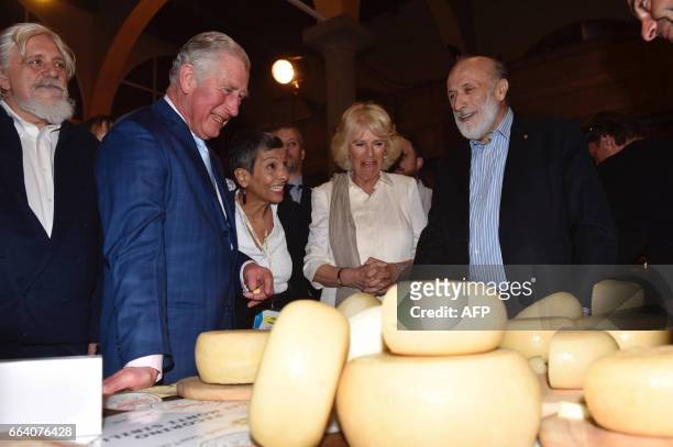 Britain's Prince Charles, his wife Camilla, the Duchess of Cornwall, and founder and president of the gastronomic movement Slow Food, Carlo Petrini ,...