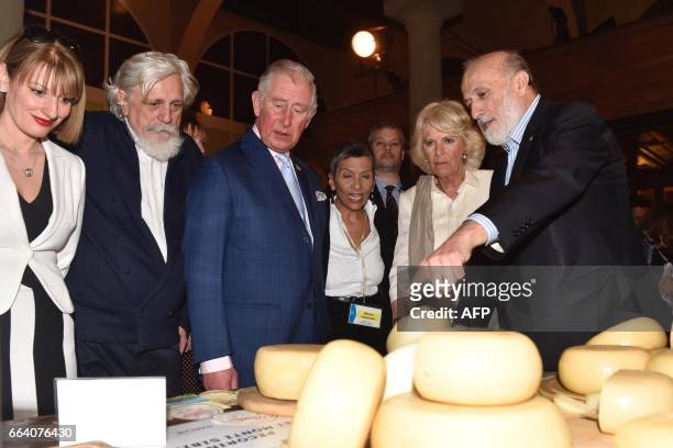 Britain's Prince Charles , his wife Camilla, the Duchess of Cornwall, and founder and president of the gastronomic movement Slow Food, Carlo Petrini...