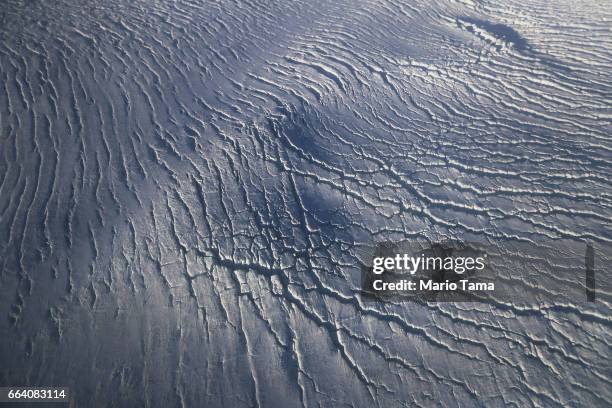 Crevasses in a glacier are seen from NASA's Operation IceBridge research aircraft along the Upper Baffin Bay coast on March 27, 2017 above Greenland....