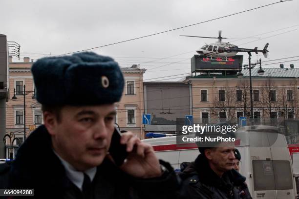Emergency vehicles and a helicopter are seen at the entrance to Technological Institute metro station in Saint Petersburg on April 3, 2017. A blast...