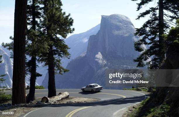 Car encounters little traffic outside of Yosemite Valley on the road to Glacier Point, high above the valley, June 18, 2000 in Yosemite National...