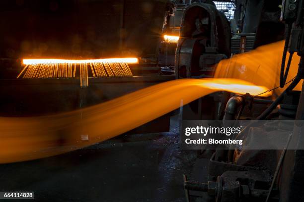 Light trails are seen as a metal billet moves during the forging process in this long exposure photograph taken at the Vaughan & Bushnell...