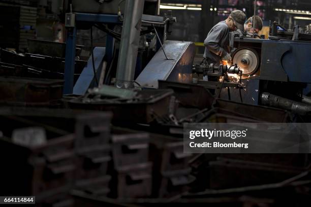 Employees sand forged metal tools at the Vaughan & Bushnell Manufacturing Co. Facility in Bushnell, Illinois, U.S., on Friday, March 31, 2017. The...