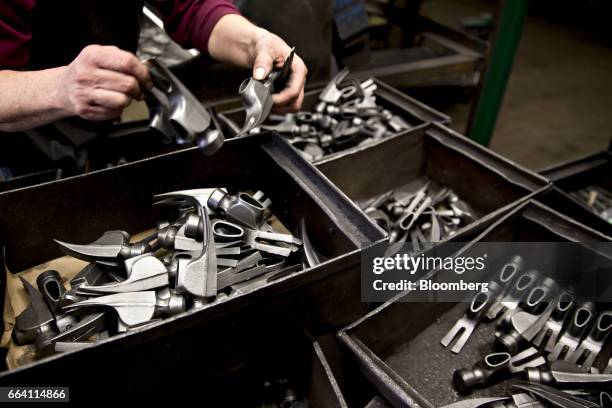 An employee inspects forged steel hammer heads at the Vaughan & Bushnell Manufacturing Co. Facility in Bushnell, Illinois, U.S., on Friday, March 31,...
