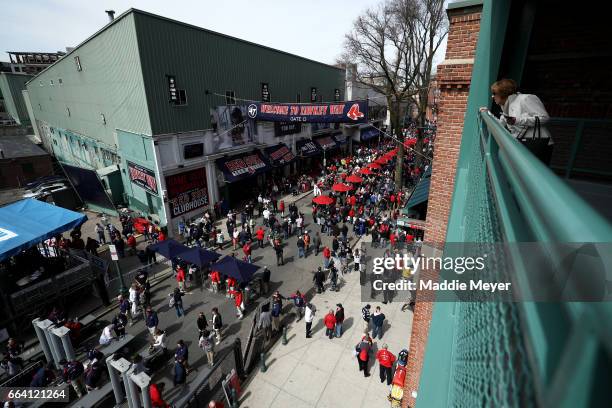 Fans walk down Yawkey Way before the opening day game between the Boston Red Sox and the Pittsburgh Pirates at Fenway Park on April 3, 2017 in...