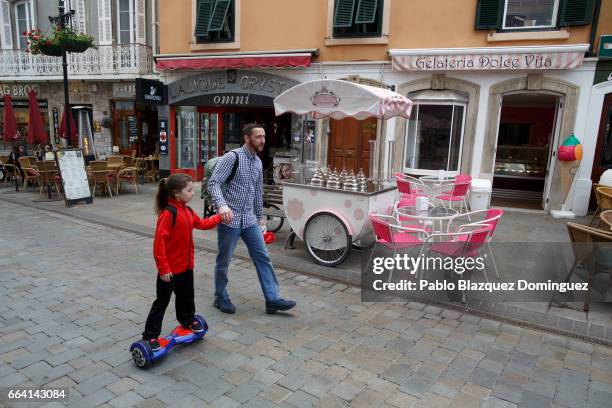 Man walks with a girl using a hoverboard in the street on April 3, 2017 in Gibraltar. Tensions have risen over Brexit negotiations for the Rock of...