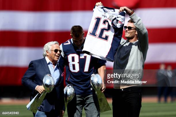 Tom Brady of the New England Patriots shows off his Super Bowl LI jersey before the opening day game between the Boston Red Sox and the Pittsburgh...