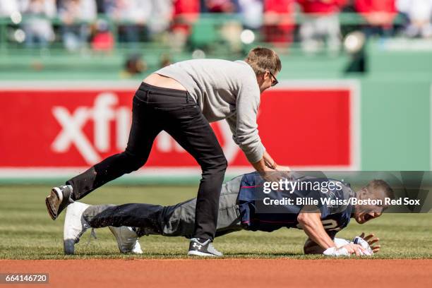 New England Partriots tight end Rob Gronkowski is chased by quarterback Tom Brady after stealing his jersey during a pre-game ceremony before the...