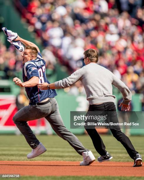 New England Partriots tight end Rob Gronkowski is chased by quarterback Tom Brady after stealing his jersey during a pre-game ceremony before the...