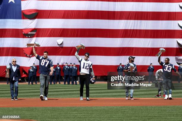 From left, New England Patriots owner Robert Kraft, Rob Gronkowski, Tom Brady, James White and Dion Lewis walk onto the field carrying Vince Lombardi...