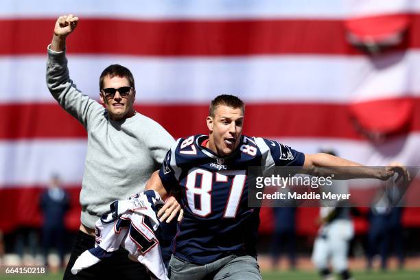 Rob Gronkowski of the New England Patriots steals Tom Brady's jersey before the opening day game between the Boston Red Sox and the Pittsburgh...
