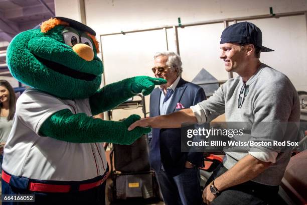 Tom Brady and owner Robert Kraft of the New England Patriots are greeted by Boston Red Sox mascot Wally before a pre-game ceremony before the Boston...