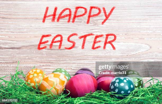 stockillustraties, clipart, cartoons en iconen met kleurrijke paaseieren op houten achtergrond en tekst happy easter - easter table