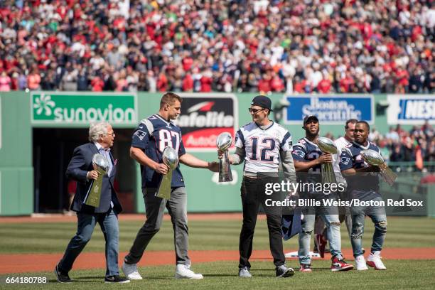 Tom Brady of the New England Patriots holds the Super Bowl trophy alongside Owner Robert Kraft, Rob Gronkowski, James White, and Dion Lewis during a...