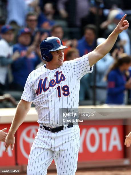 Jay Bruce of the New York Mets salutes teammate Lucas Duda after Duda drove him in with a 3 RBI double in the seventh inning against the Atlanta...