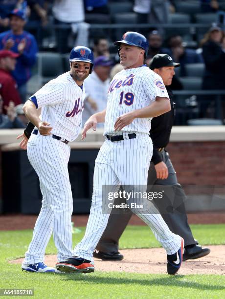 Neil Walker and Jay Bruce of the New York Mets celebrate after scoring in the seventh inning against the Atlanta Braves during Opening Day on April...