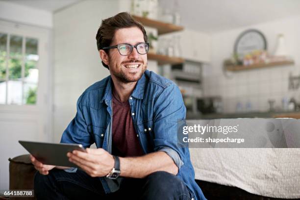 checking for fun things to do in the city - young man relaxing on sofa stock pictures, royalty-free photos & images