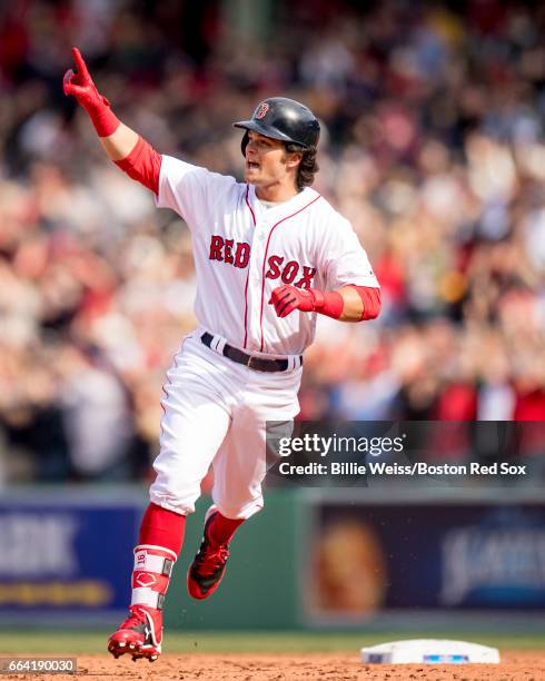 Andrew Benintendi of the Boston Red Sox reacts as he rounds the bases after hitting a three run home run during the fifth inning of the home opener...