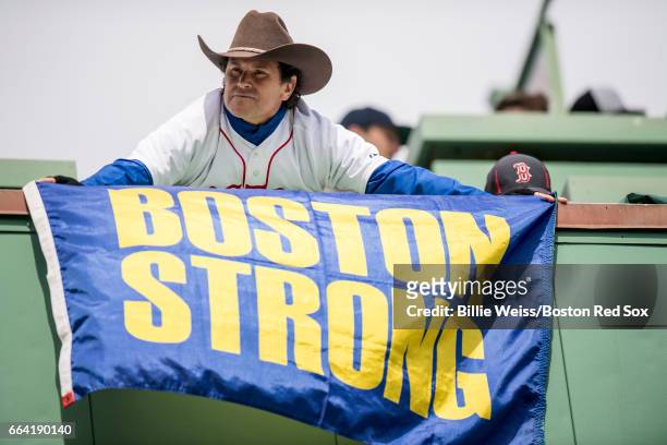 Boston Marathon bombing hero Carlos Arredondo holds a 'Boston Strong' flag before the Boston Red Sox home opener against the Pittsburgh Pirates on...