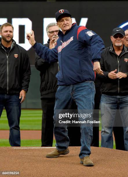 Rick Stelmaszek, former coach for the Minnesota Twins, delivers the ceremonial first pitch as former players A. J. Pierzynski, Jack Morris and Ron...