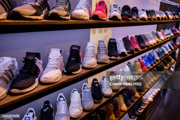 Shoes are seen at "Overkill" sneakers store on March 31, 2017 in Berlin, Germany during sale of New KAWS x Air Jordan IV sneakers. Several dozen...