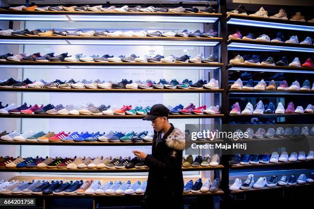 Shoes are seen at "Overkill" sneakers store on March 31, 2017 in Berlin, Germany during sale of New KAWS x Air Jordan IV sneakers. Several dozen...