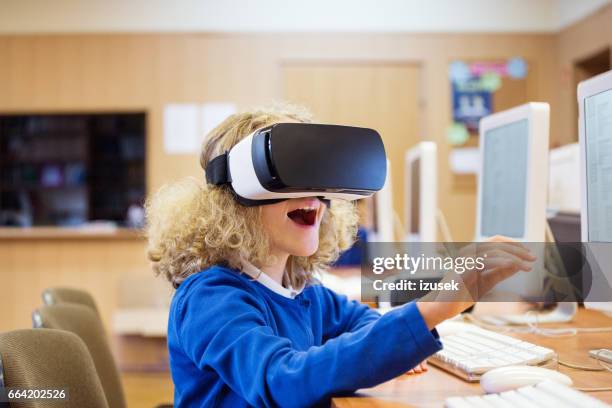 cute girl using virtual reality goggle at school - virtual reality classroom stock pictures, royalty-free photos & images