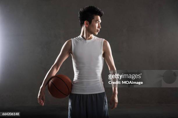 man playing basketball on gray background - man studio shot stock pictures, royalty-free photos & images