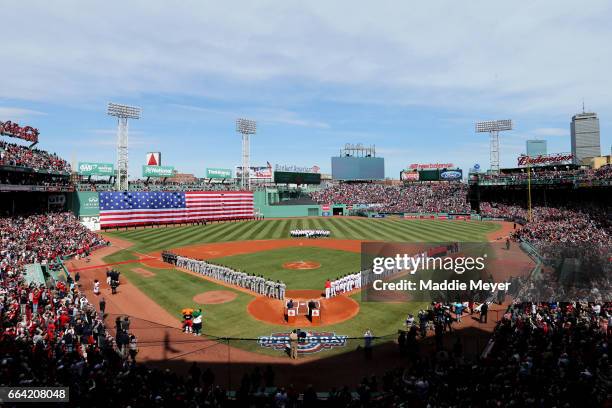 The Boston Red Sox and the Pittsburgh Pirates lineup for the national anthem before the opening day game at Fenway Park on April 3, 2017 in Boston,...