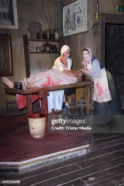 Sarah Tkotsch and protagonist Claudia pose during the VIP Theatre Event At Berlin Dungeon on April 03, 2017 in Berlin, Germany.