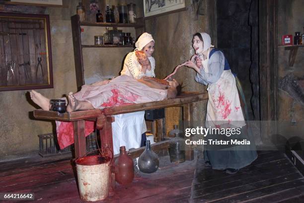 Sarah Tkotsch and protagonist Claudia pose during the VIP Theatre Event At Berlin Dungeon on April 03, 2017 in Berlin, Germany.