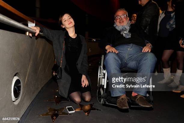 Actress Louise Bourgoin and director Dominique Farrugia pose near the stars to their name before 'Sous Le Meme Toit' Premiere at Kinepolis on April...