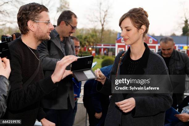 Actress Louise Bourgoin takes selfies with fans before 'Sous Le Meme Toit' Premiere at Kinepolis on April 3, 2017 in Lille, France.