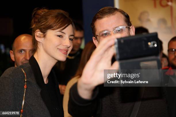 Actress Louise Bourgoin takes selfies with fans before 'Sous Le Meme Toit' Premiere at Kinepolis on April 3, 2017 in Lille, France.