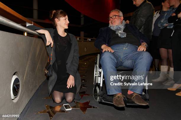 Actress Louise Bourgoin and director Dominique Farrugia pose near the stars to their name before 'Sous Le Meme Toit' Premiere at Kinepolis on April...