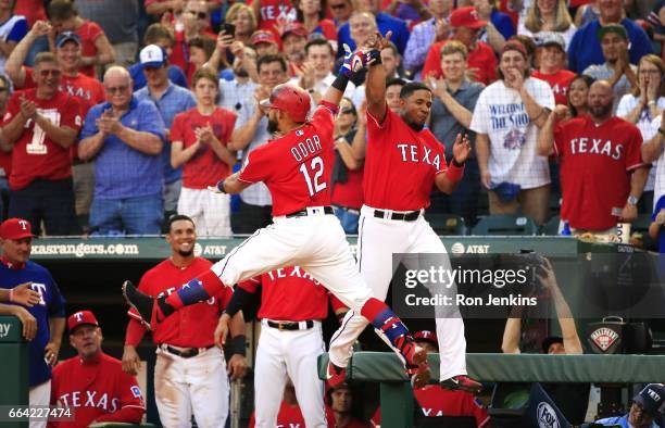 Rougned Odor of the Texas Rangers celebrates with teammate Elvis Andrus after Odor hit a solo home run against the Cleveland Indians in the second...