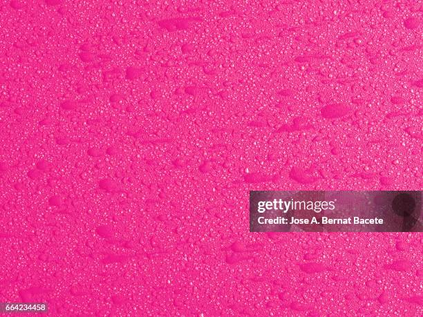 full frame of coarse and wavy textures of colored foam, pink background - simetría stockfoto's en -beelden