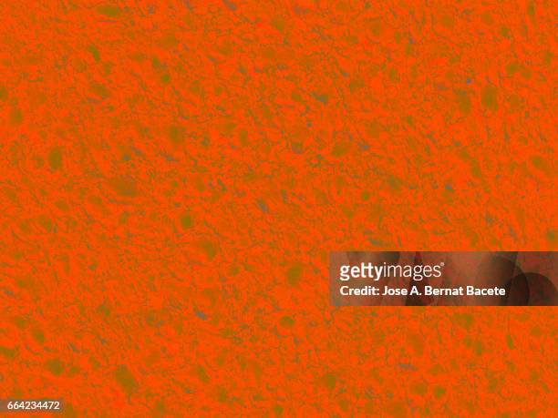 full frame of coarse and wavy textures of colored foam, orange background - agujero stockfoto's en -beelden